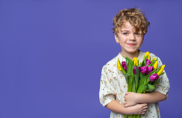 Cute caucasian laughing preschool girl standing over purple background, hold bouquet of yellow...