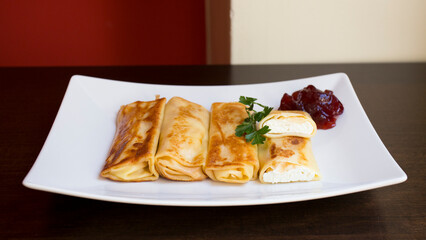 A blini, or sometimes blin, is a Russian and more broadly Eastern European pancake that is traditionally made from buckwheat or wheat flour today and served with smetana, tvorog, butter, caviar, ...