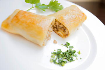 A blini, or sometimes blin, is a Russian and more broadly Eastern European pancake that is traditionally made from buckwheat or wheat flour today and served with smetana, tvorog, butter, caviar, ...