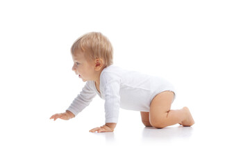 Little, happy and smiling cute baby in the studio. Portrait of a one year old baby. The concept of happiness.