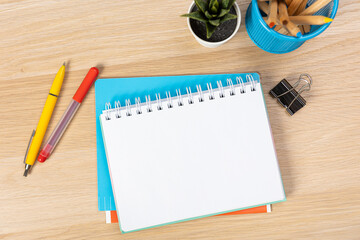 Notebook mockup with school stationery on a wooden table. back to school concept. Blank notepad with copy space. list of goals and plans for new year 2023