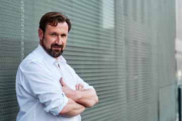 Portrait of a businessman in white shirt with arms crossed