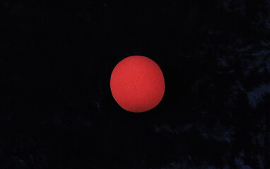 Red Nose Day, red nose of a clown on a black background