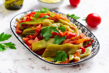 Homemade stewed green beans, tomatoes, garlic with olive oil. Zeytinyagli fasulye traditional food. Turkish cuisine.