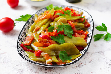 Homemade stewed green beans, tomatoes, garlic with olive oil. Zeytinyagli fasulye traditional food. Turkish cuisine.