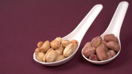 Close up of Salted Peanuts Indian namkeen (snacks) on a ceramic white bowl. Top view