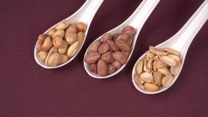 Close up of Salted Peanuts Indian namkeen (snacks) on a ceramic white bowl. Top view