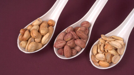 Close up of Salted Peanuts Indian namkeen (snacks) on a ceramic white bowl. Top view