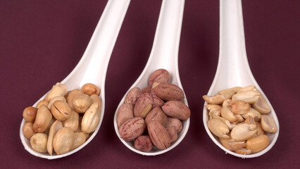 Close up of Salted Peanuts Indian namkeen (snacks) on a ceramic white bowl. Top view