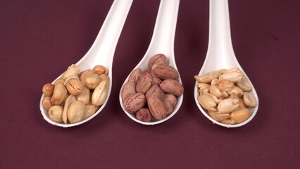 Close up of Salted Peanuts Indian namkeen (snacks) on a ceramic white bowl. Top view