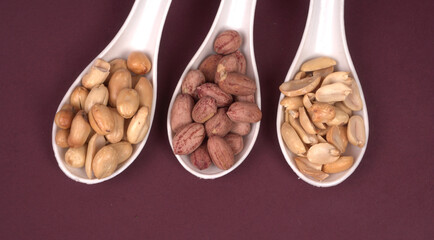 Close up of Salted Peanuts Indian namkeen (snacks) on a ceramic white bowl. Top view