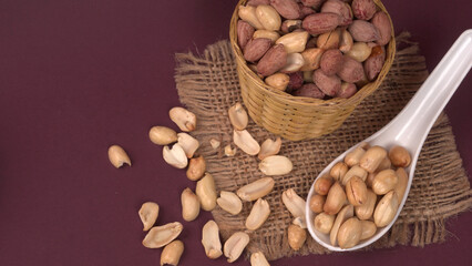 Close up of Salted Peanuts Indian namkeen (snacks) on a ceramic white bowl. Top view