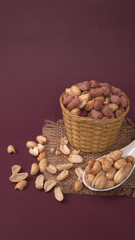 Close up of Salted Peanuts Indian namkeen (snacks) on a ceramic white bowl. Top view