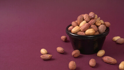 Close up of Salted Peanuts Indian namkeen (snacks) on a ceramic white bowl. Top view