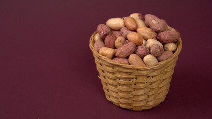 Close up of Salted Peanuts Indian namkeen (snacks) on a ceramic white bowl. Top view