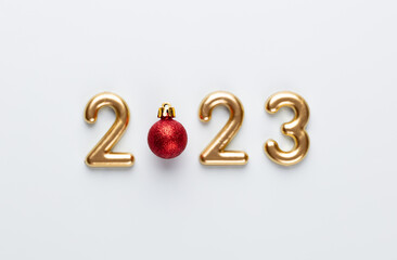 New year 2023 number, golden digits and santa hat over blue background. - 560346993