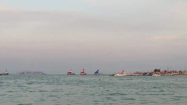 Qatar has some free beach.women can swim with swimsuit. every evening local doats with World cup countries' flags on it pass the beach and tourists taking photo and enjoying. Katara beach, Doha 2022.