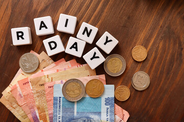 Concept of saving for unforeseen circumstances. Emergency saved fund or money. South African currency the Rand in the background 