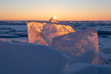 Winter sunrise at Lake Baikal, Russia. Blue ice at sunlight.