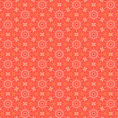 Delicate geometric pattern of pink, red, white and yellow polka dots isolated on a coral orange background