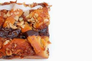Delicious cake with peanut butter cream layer and chocolate topping. Bakery white background. Selective focus