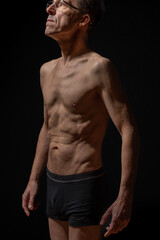 Fototapeta na wymiar Paris, France - 01 09 2023: still life. Studio shot of a mature man posing shirtless