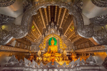 Inside the silver chapel with gold Buddha statue at Wat Sri Suphan, Chiang Mai, Thailand