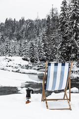 Chair in winter landscape, relaxing in nature concept
