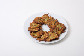 Traditional Turkish Zuccini Mucver. Mucver is a Turkish fritter or pancake, made from grated zucchini isolated on white background