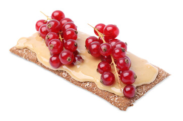 Fresh crunchy rye crispbread with peanut butter and red currant isolated on white