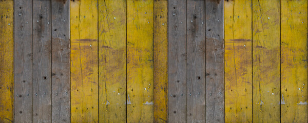 Abstract grunge old yellow painted scratched wooden boards wall texture - wood background panorama long banner