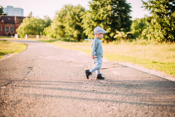 Fototapeta premium Cute and handsome baby boy 1-2 years old exploring nature in summer, having fun