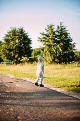 Fototapeta premium Cute and handsome baby boy 1-2 years old exploring nature in summer, having fun