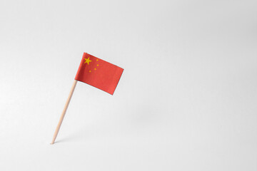 Small paper flag of China on light background. Space for text