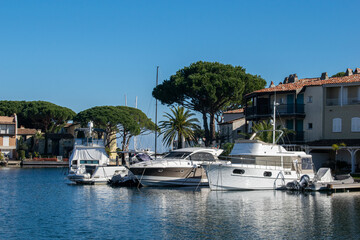 Port grimaud hotels boats and river with palm tree