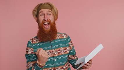 Hippie redhead man open envelope take out letter reads it feel happy. Career growth advance promotion bank loan approve monetary award long-awaited invitation great new. Hipster guy on pink background