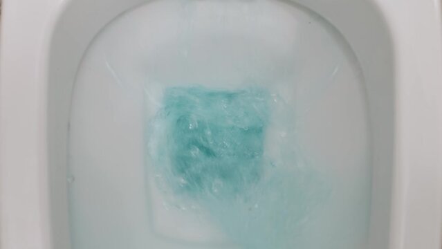 Flush toilet. Water flushes the toilet. Water saving concept. Slow motion