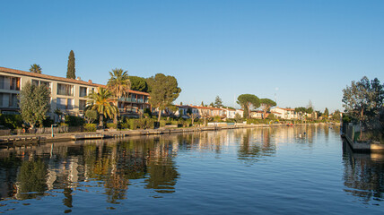 Fototapeta na wymiar Port Grimaud house on river shore with yachts