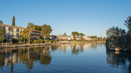Fototapeta premium Port Grimaud house on river shore with yachts