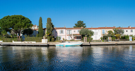 Fototapeta na wymiar Port Grimaud house on river shore with yachts