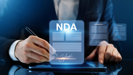 Non disclosure agreement concept. Businessman signs NDA document
