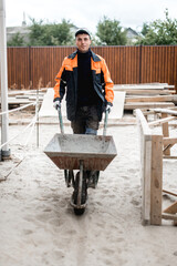 Young construction worker outdoors. Renovation background.