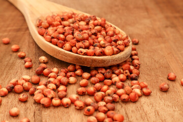 Macro photo of Red Sorghum on a wooden spoon