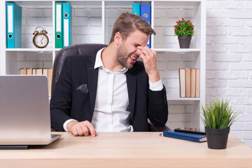 stressed businessman has headache in studio. stressed businessman has headache on background.