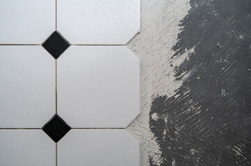 Floor tile octagon in process of laying. Half of floor is unrefurbished - obrazy, fototapety, plakaty