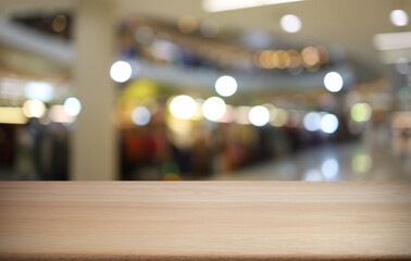 Wood table top in front of abstract blurred background. Empty wooden table space for text marketing promotion. blank wood table surface copy space