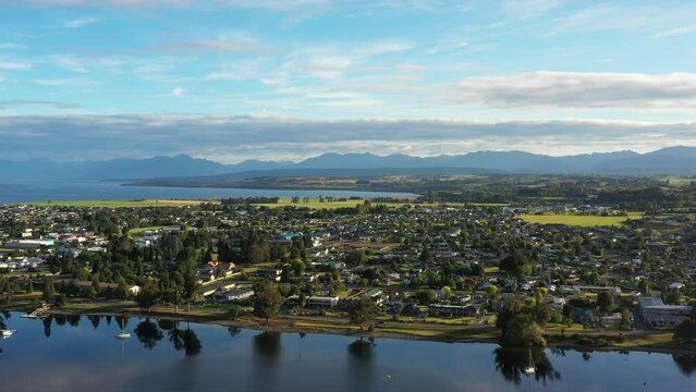Calm Te Anau town reflection in Te Anau lake of New Zealand &ndash; aerial 4k.
