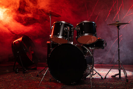 Drums and drum set. Beautiful blue and red background, with rays of light. Beautiful special effects of smoke and lighting. Musical instrument. The concept of music. Close-up photo.