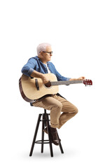 Mature man sitting on a chair playing an acoustic guitar