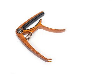 Metal capo for guitar with spring painted wood.